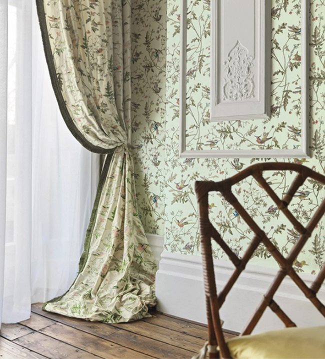 Cole & Son Hummingbirds design used as bird wallpaper and fabric with hummingbirds darting through stylised branches