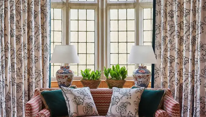 Patterned curtain fabric used for full-length curtains in an elegant living room