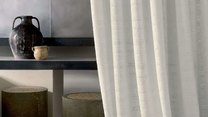 Natural linen-look voile curtain fabric softly filtering the daylight as a sheer fabric