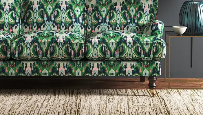 Green and navy Ikat-inspired fabric used on a traditionally shaped sofa