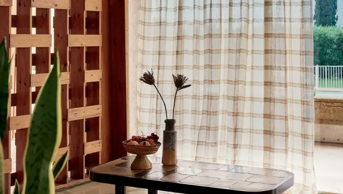 Checked linen sheer curtains filtering daylight in a contemporary natural interior