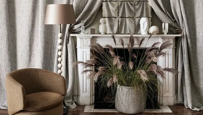 Viscose fabric curtains and upholstered chair in an elegant neutral interior
