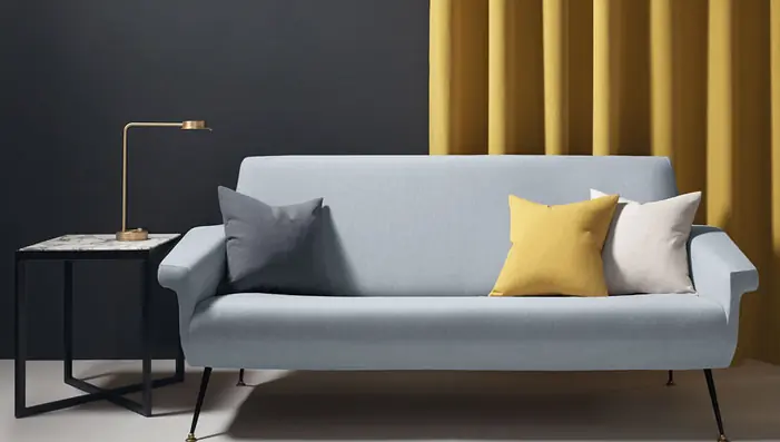 Contemporary sofa upholstered in washable grey fabric with coordinating cushions