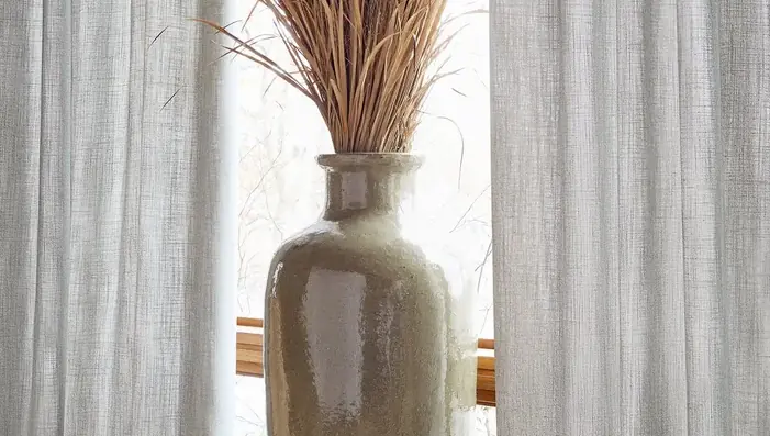Natural wide-width linen curtains across a large contemporary window