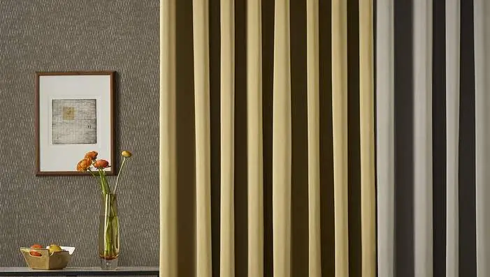Sekers Abisko satin and woven effect curtain fabrics styled within a luxury hospitality interior