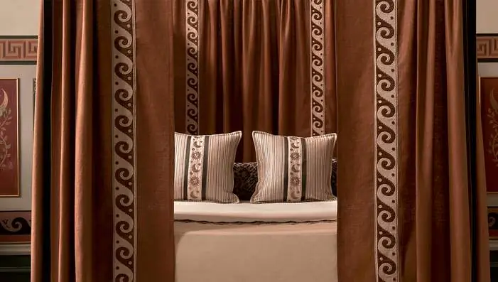 Travers Arcadia trimmings featuring chequerboard brush fringe, Greek Key embroidery and handwoven tassel tape