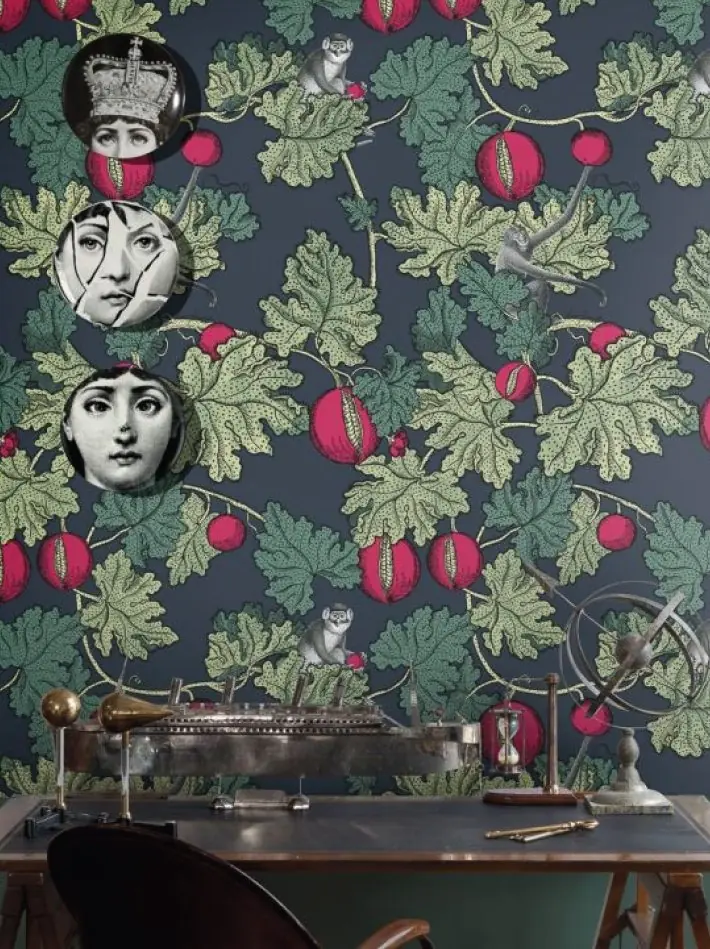 Frutto Proibito wallpaper by Cole & Son featuring fig leaves, red fruits and surreal illustrated faces with playful monkey motifs