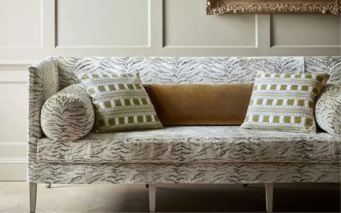 Tiger Velvet animal print upholstery fabric by James Hare on an accent chair