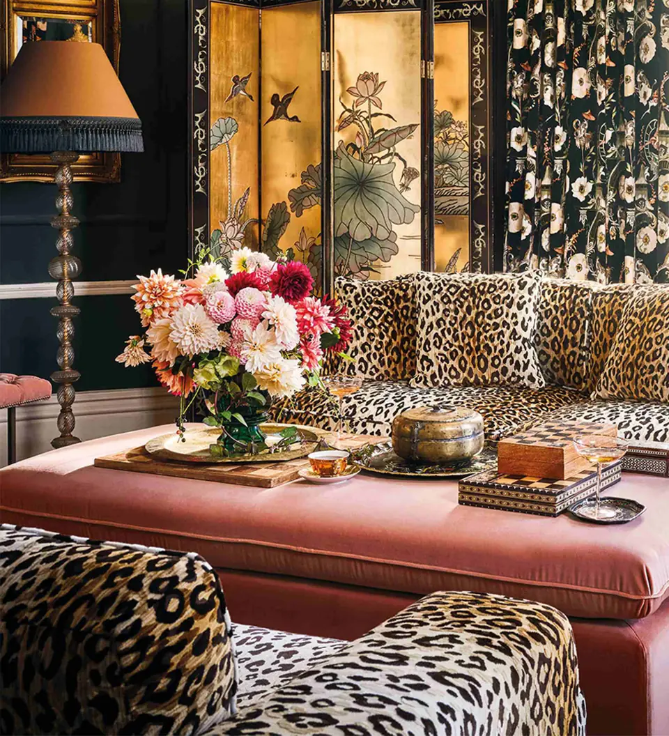 Mimi velvet leopard-style animal print upholstery fabric by Romo on a sofa