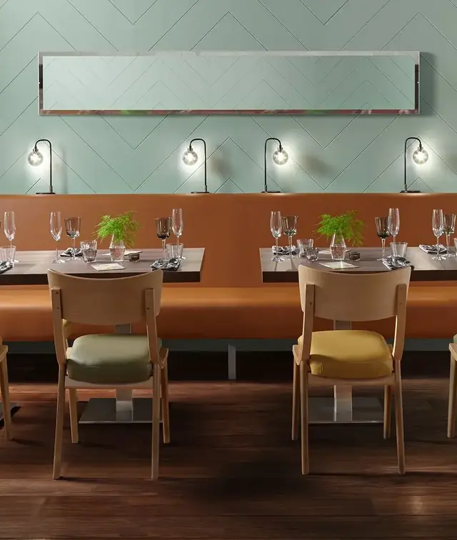 Tan vinyl banquette and upholstered dining chairs in a contemporary restaurant