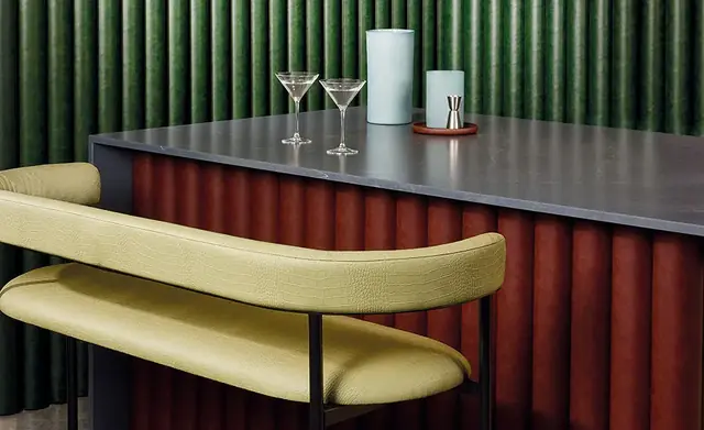 Faux leather upholstered banquette seating in a contemporary bar interior