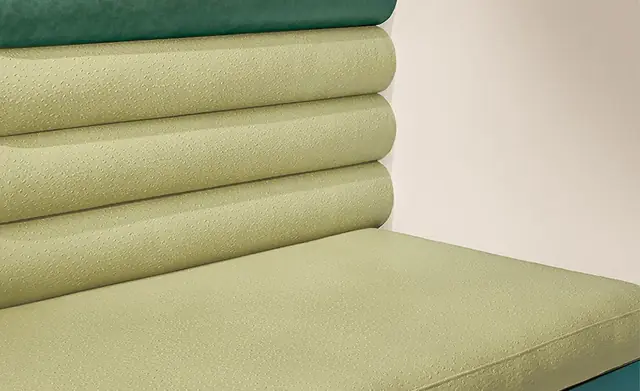 Close-up of pale green embossed faux leather upholstery