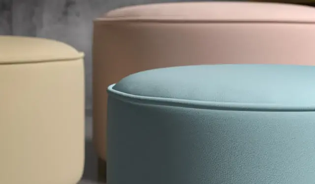 Close-up of pastel vinyl upholstery showing fine grain and piped edges