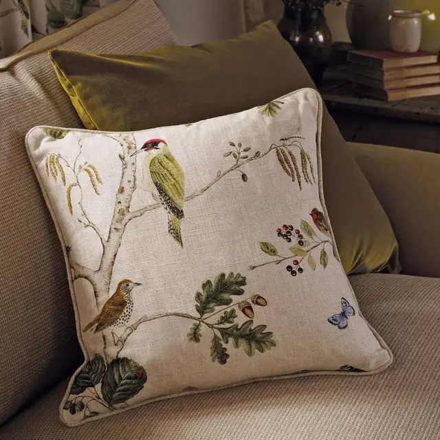 Bird fabric upholstered armchair in a woodland setting