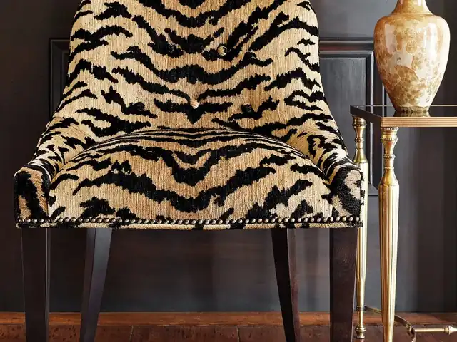 Black and warm tan animal-pattern fabric on an upholstered chair