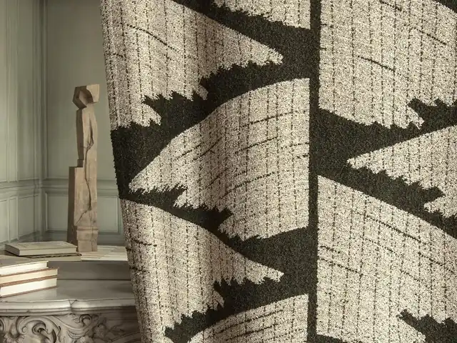 Black geometric pattern on a natural-coloured woven curtain