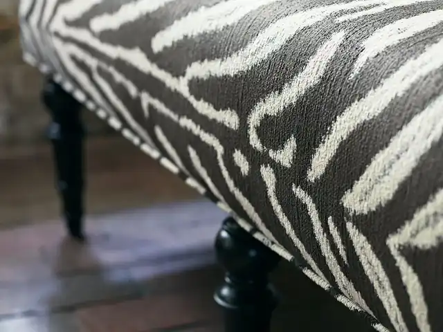 Black and ivory zebra-pattern fabric on an upholstered ottoman
