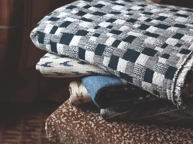 Layered blue, cream and brown fabrics with checks and woven textures