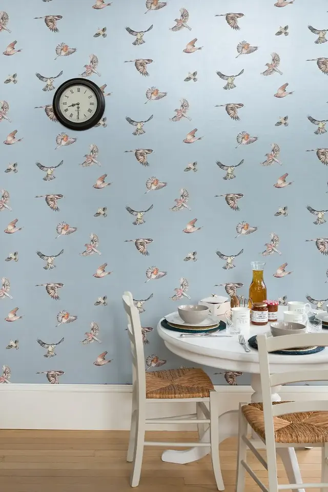 Blue Juliet Travers Early Bird wallpaper with flying birds in a bright dining room
