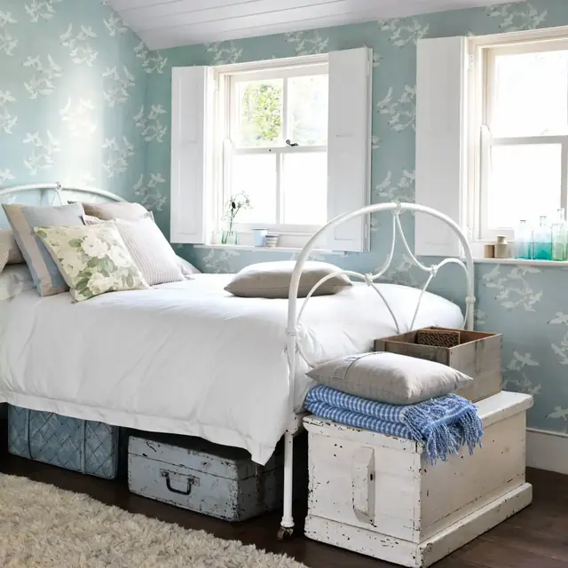Blue Sanderson seagull bird wallpaper shown across a bright bedroom