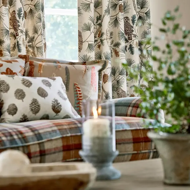 Botanical bird fabric used on a decorative cushion
