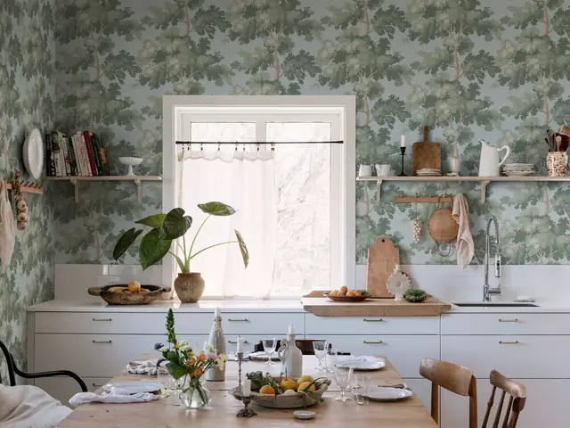 Green botanical wallpaper in a bright kitchen