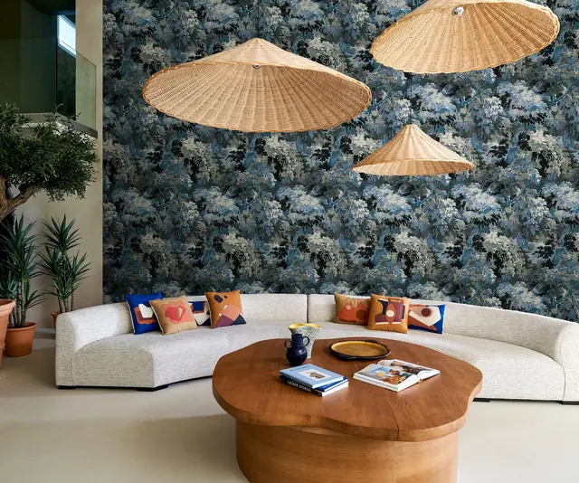 Dark blue botanical wallpaper in a luxury contemporary living room