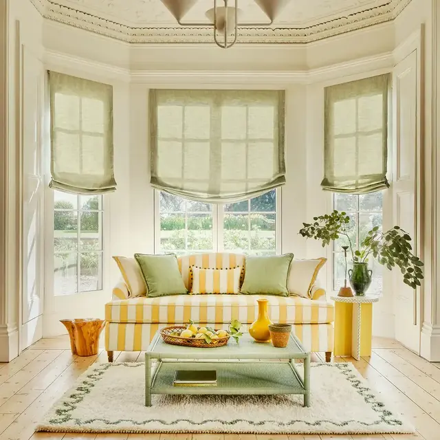 Broad yellow and white striped upholstery fabric on a sofa