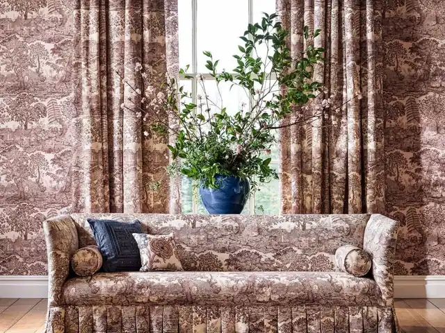 Brown and cream toile fabric used together on curtains and a sofa