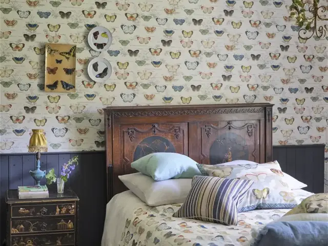 Natural-history butterfly wallpaper in a softly styled bedroom