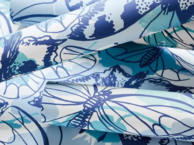 Close-up of blue butterfly wallpaper showing pattern scale and colour