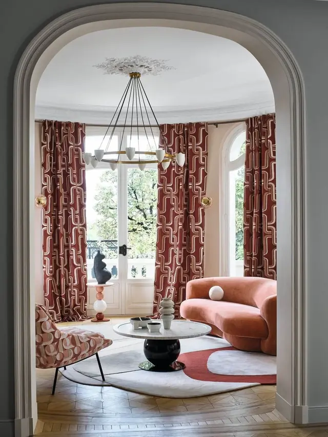 Geometric patterned curtains and coordinating upholstery in an elegant sitting room