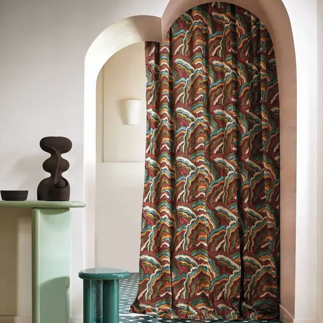 Casamance Annella patterned curtain fabric forming deep full-length folds