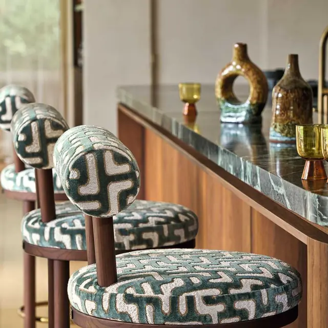 Casamance Bryce geometric fabric upholstered on curved dining chairs