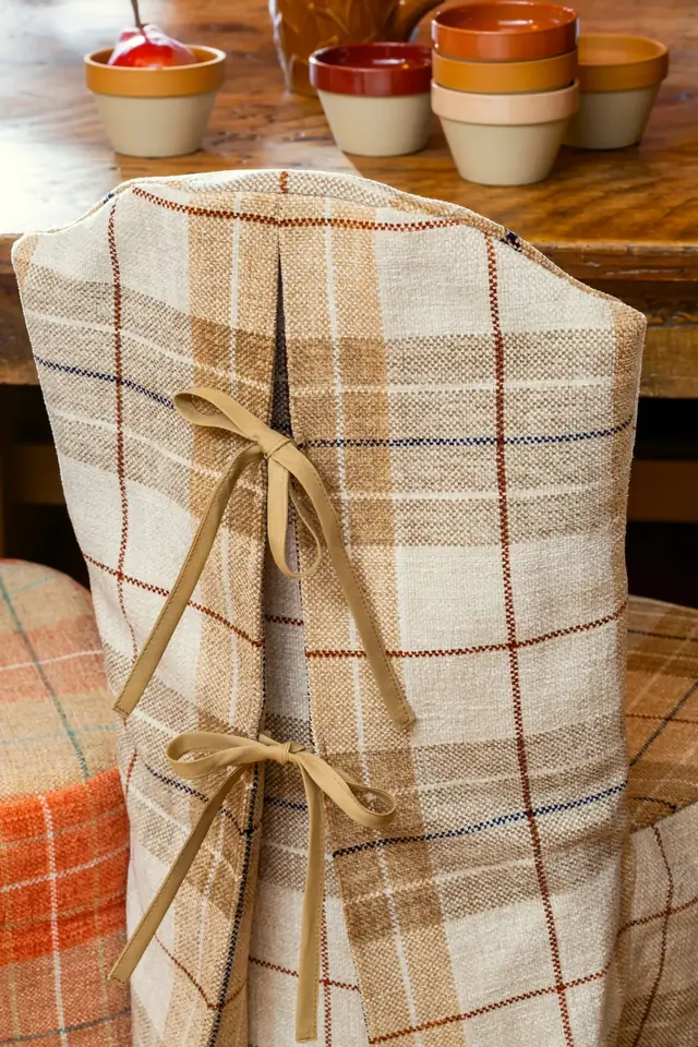 Neutral checked woven fabric tailored around a dining chair with tie details