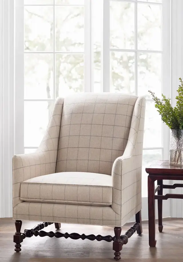 Neutral checked wool upholstery fabric on a high-backed armchair