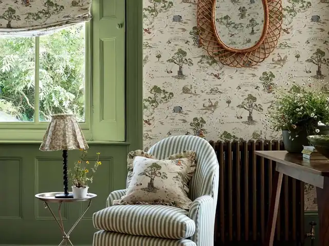 Hundred Acre Wood storybook wallpaper in a green children’s room