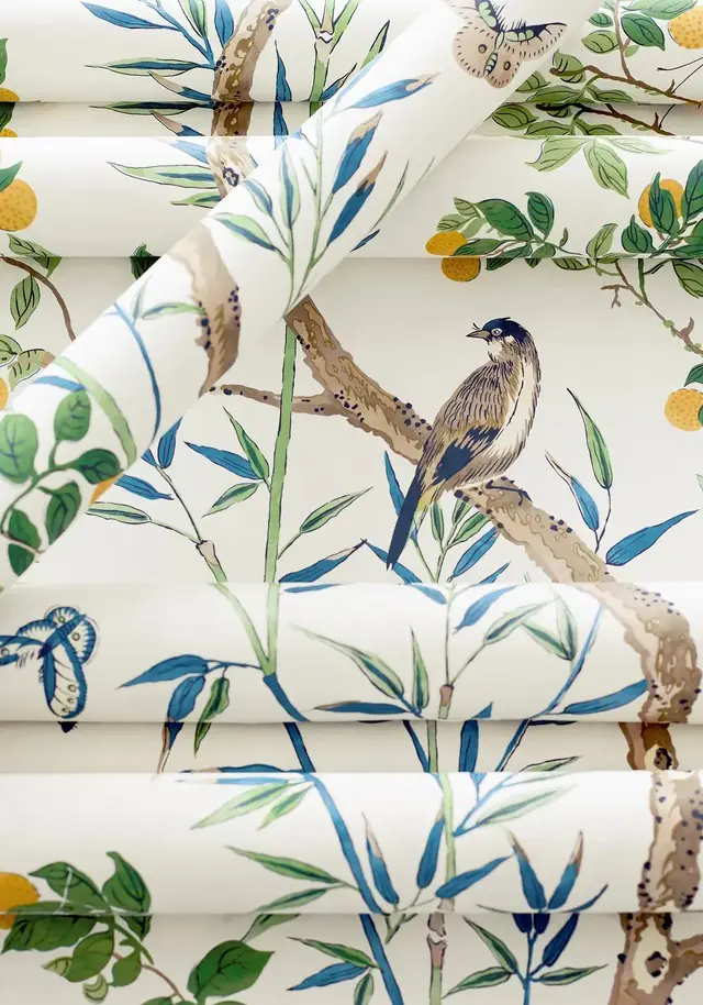 Blue and white Chinoiserie wallpaper rolls showing birds, leaves, colour and printed detail
