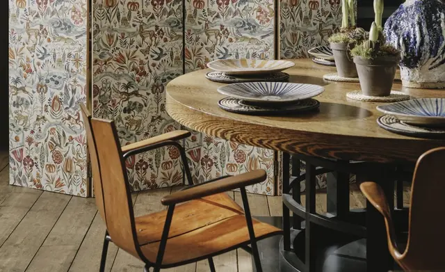Christopher Farr Cloth patterned textile screens in a furnished dining room