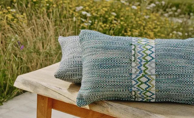 Christopher Farr Cloth textured cushions with a decorative woven border
