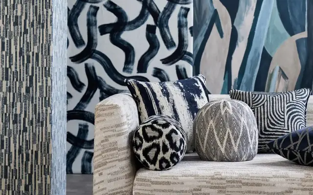 Clarke and Clarke contemporary wallpaper, upholstery and cushions in a blue interior