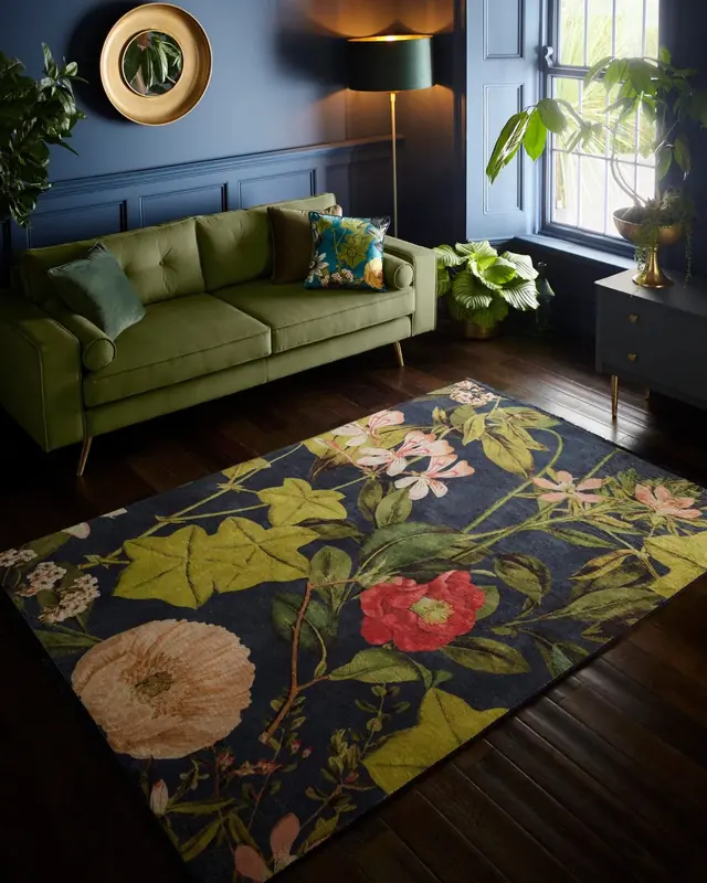 Clarke and Clarke floral rug with green sofa in a dark blue living room