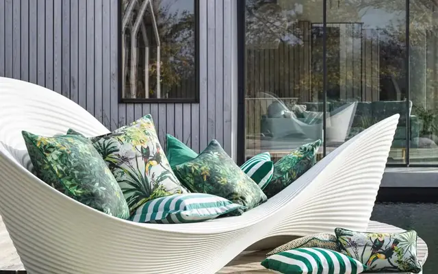 Clarke and Clarke patterned outdoor cushions beside a contemporary home
