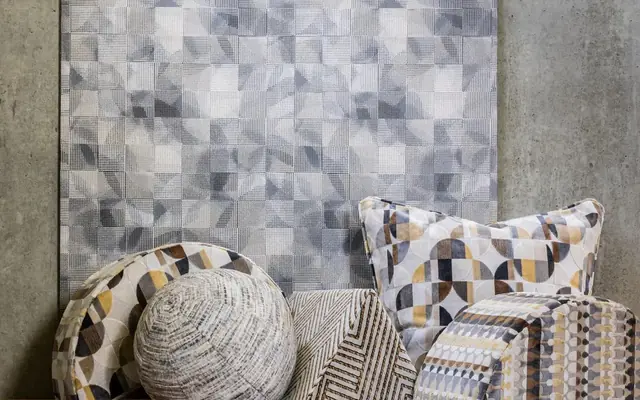 Clarke and Clarke geometric wallpaper with coordinated patterned cushions