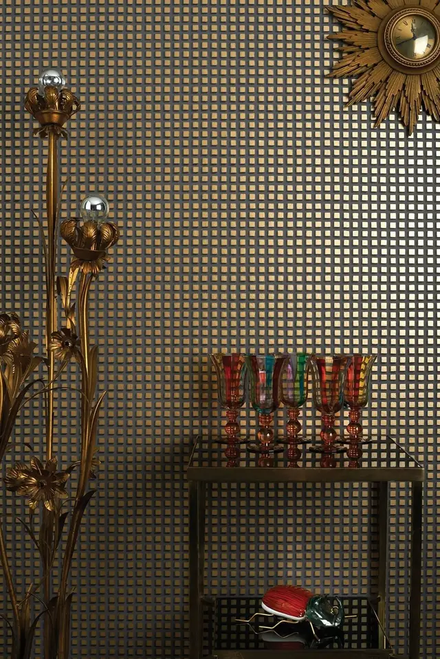 Cole and Son Mosaic gold and charcoal geometric Art Deco wallpaper in a dining room