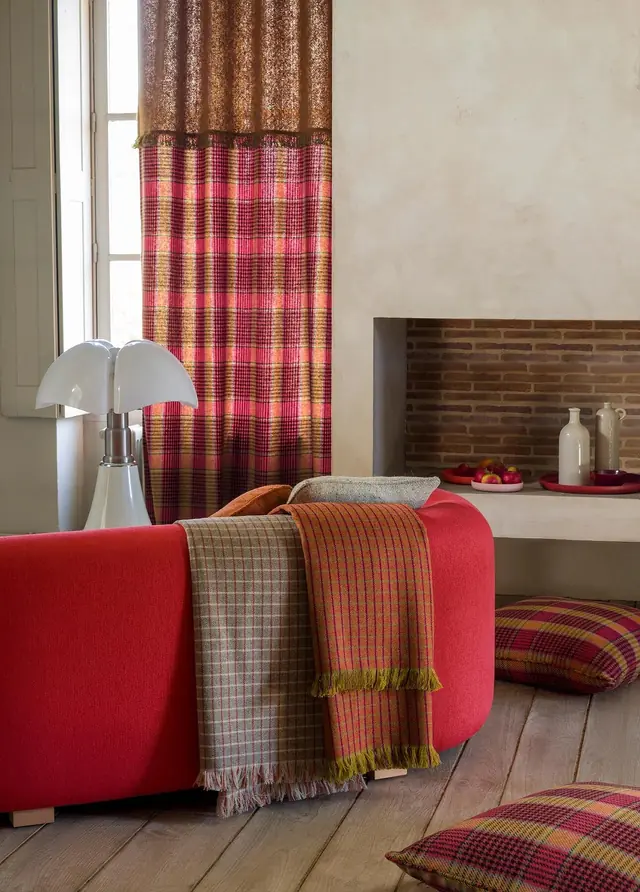 Colourful plaid check curtains and coordinating throws in a contemporary interior