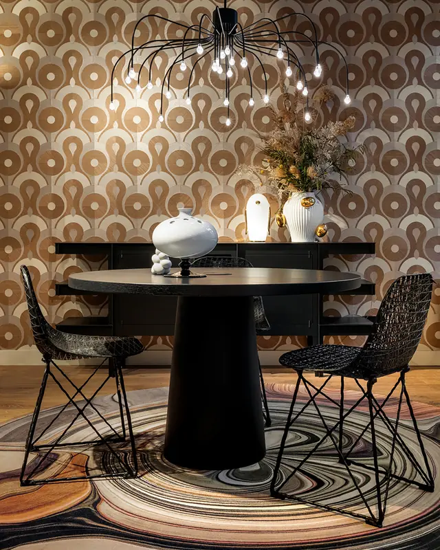 Large contemporary circular motifs on neutral wallpaper in a modern dining room