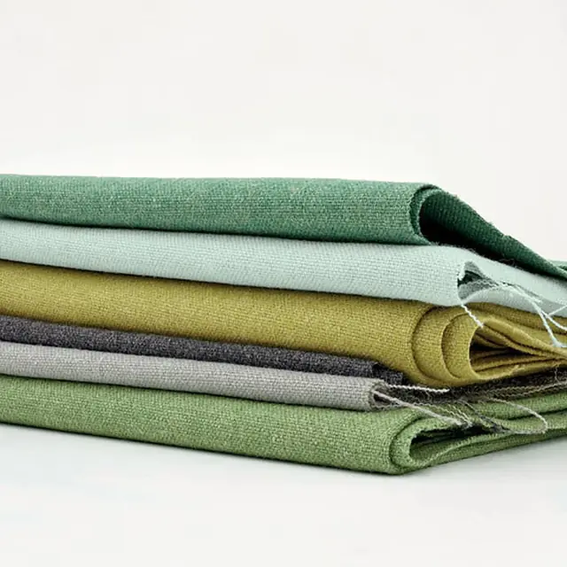 Stack of textured contract upholstery fabrics in coordinating colours