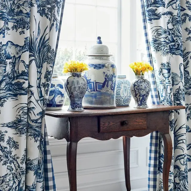 Blue and white patterned cotton curtain fabric in a traditional interior