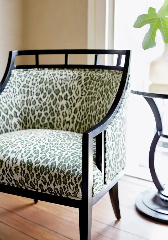 Green patterned cotton upholstery fabric on a tailored armchair